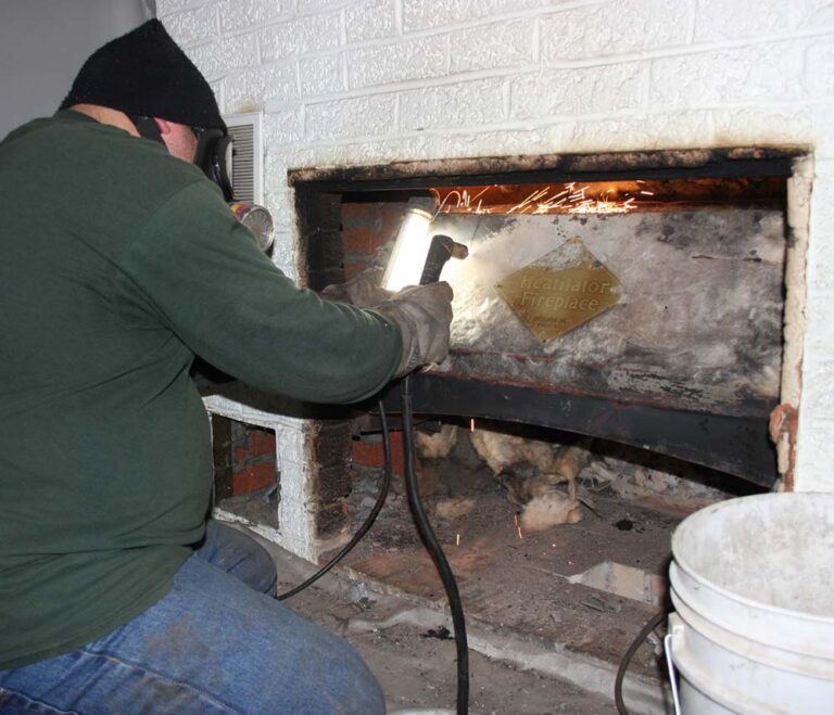 Man doing fireplace firebox repair